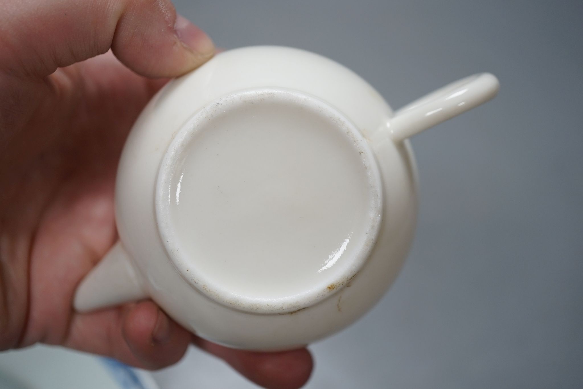 A Chinese blue and white plate, 23.5 cm, a similar tea bowl and saucer, a saucer and a white glaze teapot and cover, 18th century and later